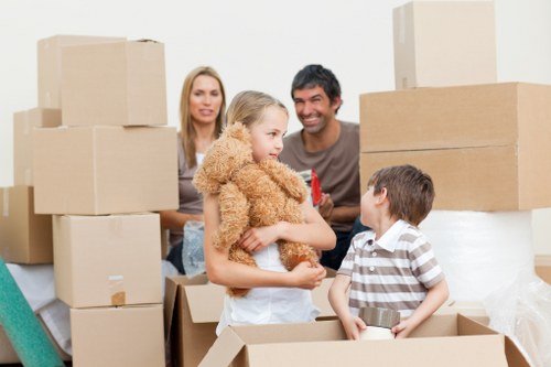 Professional movers handling office equipment
